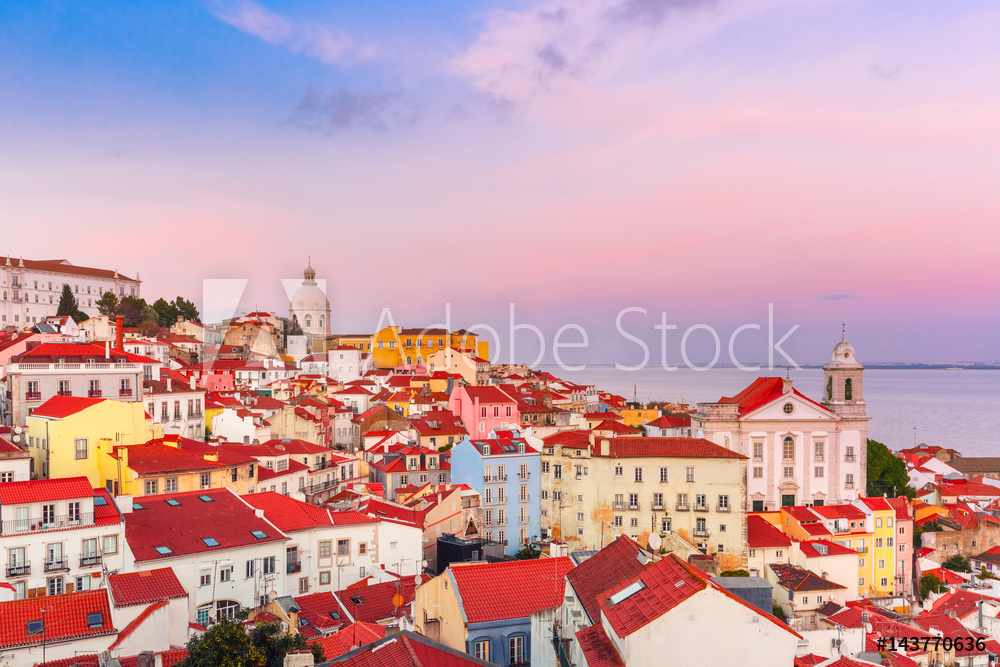 View of Alfama, the oldest district of the Old Town, Church of Saint Stephen and National Pantheon from belvedere Miradouro das Portas do Sol at scenic sunset, Lisbon, Portugal