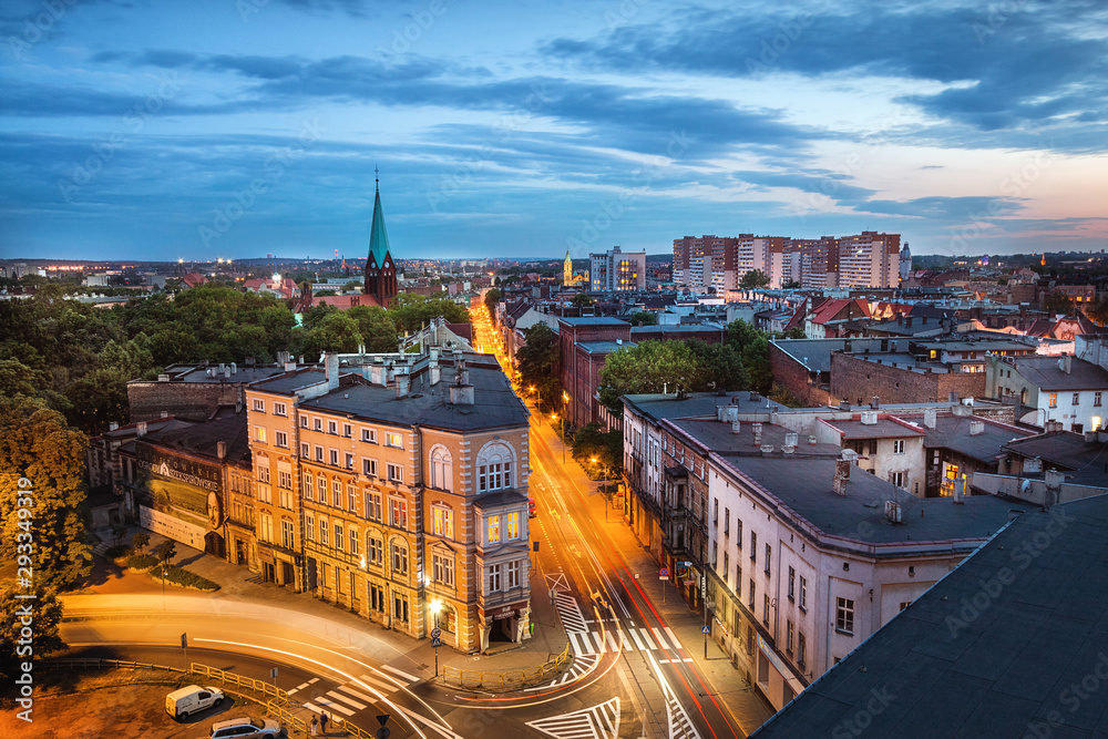 Widok na Chorzów o zmierzchu, przedstawiający miejską architekturę Górnego Śląska.