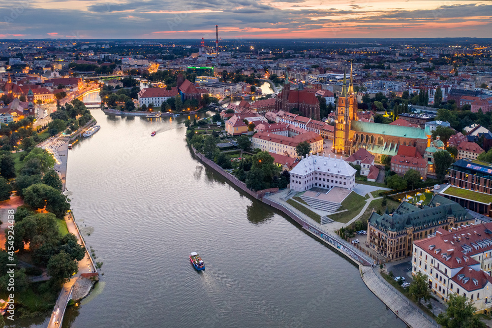 Nocny widok na Wrocław z lotu ptaka, oświetlone zabytki i rzeka Odra